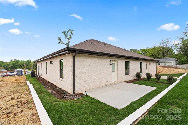 2429/2425 Ellen Ave, Charlotte, NC 28208 - rear view of house with fence, a yard, central air condition unit, a patio area, and roof with shingles