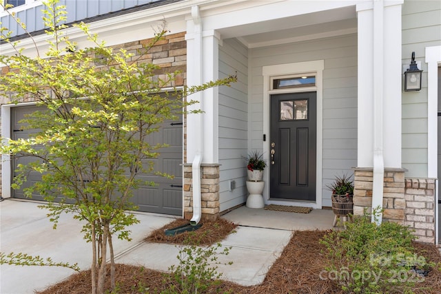 entrance to property with covered porch and stone siding