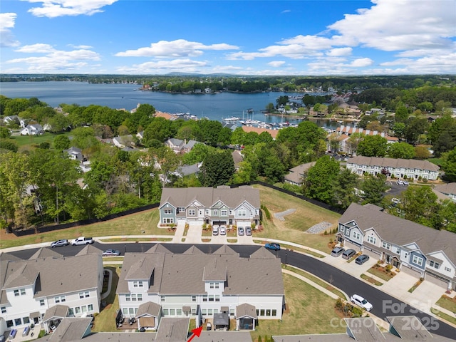 birds eye view of property with a water view and a residential view