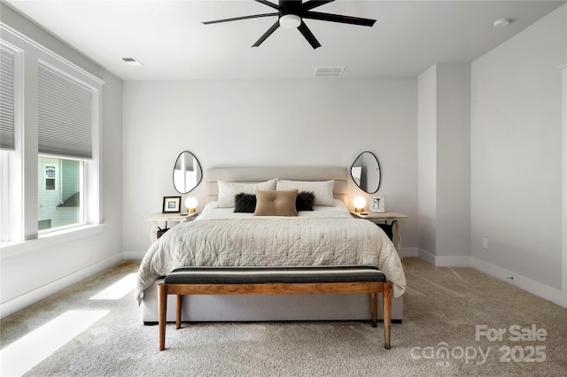 carpeted bedroom featuring visible vents, a ceiling fan, and baseboards