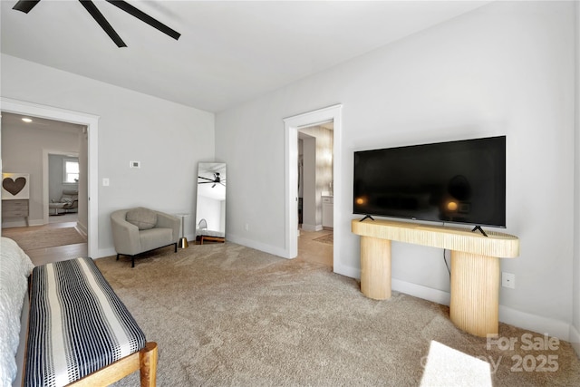 living area featuring baseboards, ceiling fan, and carpet flooring