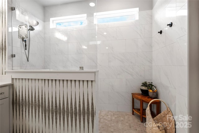 full bathroom with a walk in shower and vanity