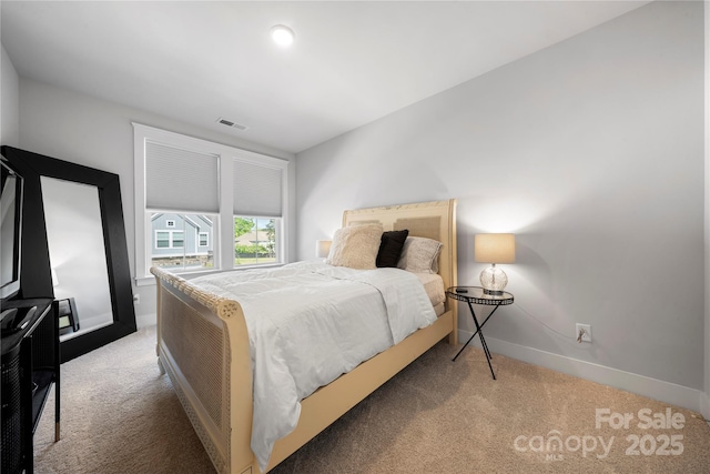 bedroom with baseboards, visible vents, and carpet