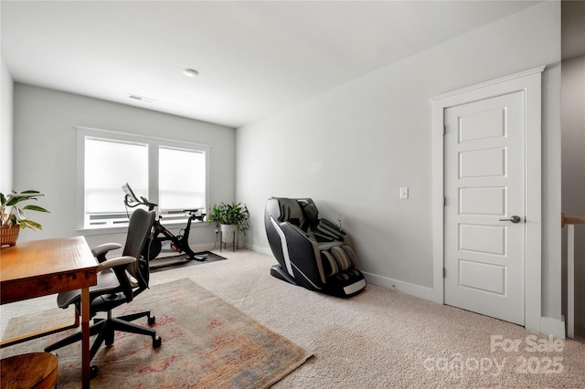 carpeted office space featuring baseboards and visible vents
