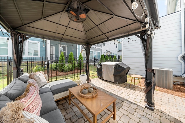 view of patio with fence, a gazebo, an outdoor living space, and area for grilling