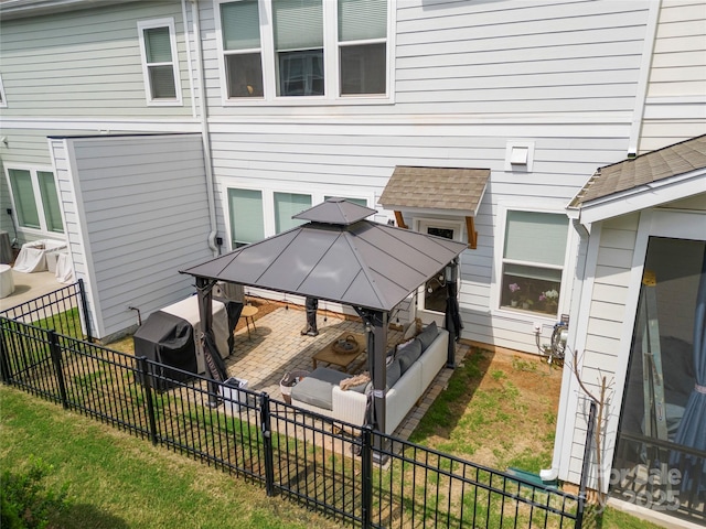 rear view of house featuring a gazebo, a fenced backyard, and a patio