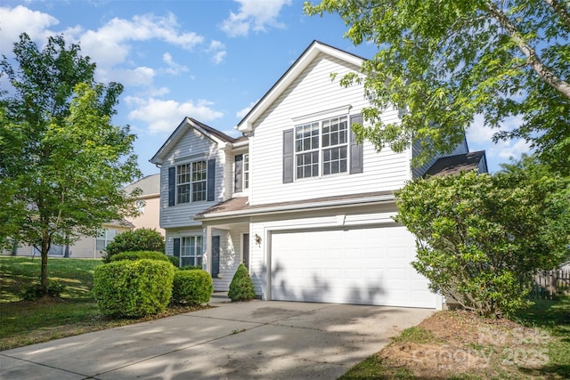 traditional-style home featuring concrete driveway and an attached garage
