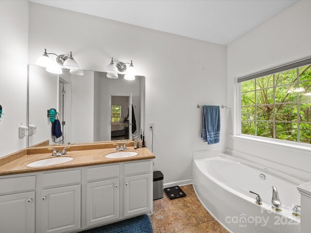 bathroom with double vanity, a whirlpool tub, and a sink