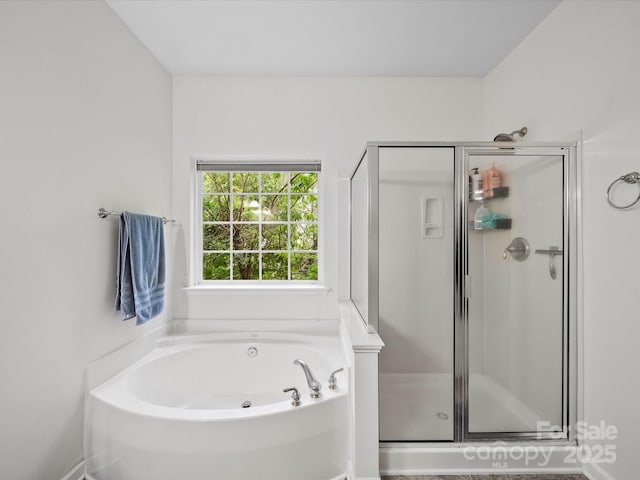 full bath featuring a garden tub and a shower stall