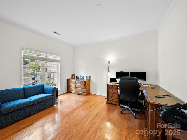 office area with visible vents, light wood-type flooring, and ornamental molding