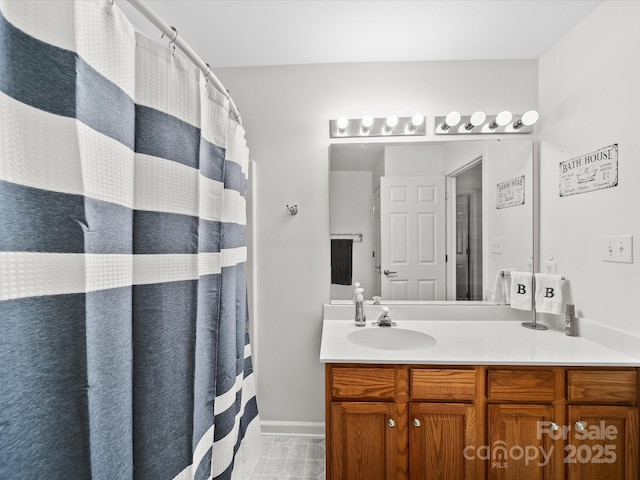 full bathroom with tile patterned floors, vanity, a shower with shower curtain, and baseboards