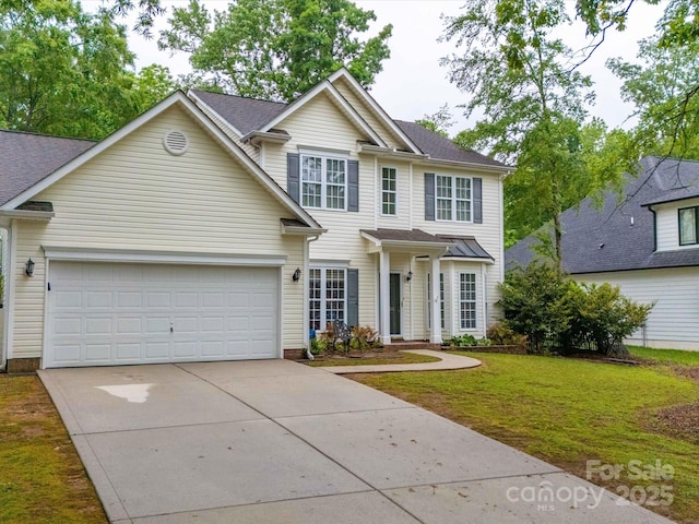 view of front facade featuring a front lawn, driveway, and an attached garage