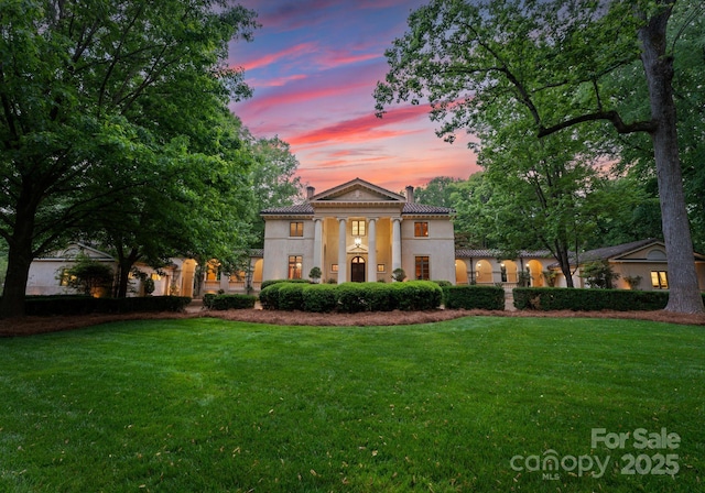 5030 Hardison Rd, Charlotte, NC 28226 - neoclassical / greek revival house with a tiled roof, a chimney, a front lawn, and stucco siding