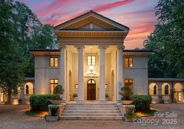 5030 Hardison Rd, Charlotte, NC 28226 - greek revival house featuring a tile roof and stucco siding