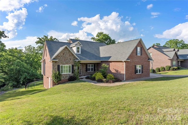 444 Snapdragon Dr, Clover, SC 29710 - view of front of home with a front yard, brick siding, a shingled roof, and stone siding