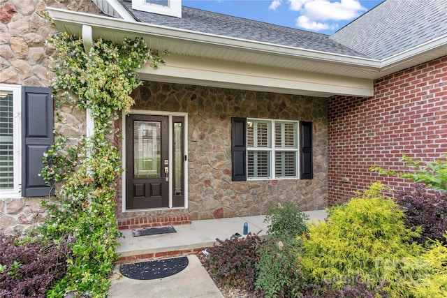444 Snapdragon Dr, Clover, SC 29710 - doorway to property featuring stone siding, a shingled roof, and covered porch