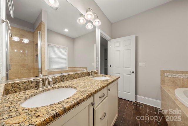 444 Snapdragon Dr, Clover, SC 29710 - full bath featuring a bath, baseboards, wood tiled floors, double vanity, and a tile shower