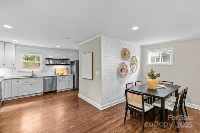 dining area featuring baseboards, ornamental molding, recessed lighting, and dark wood-type flooring