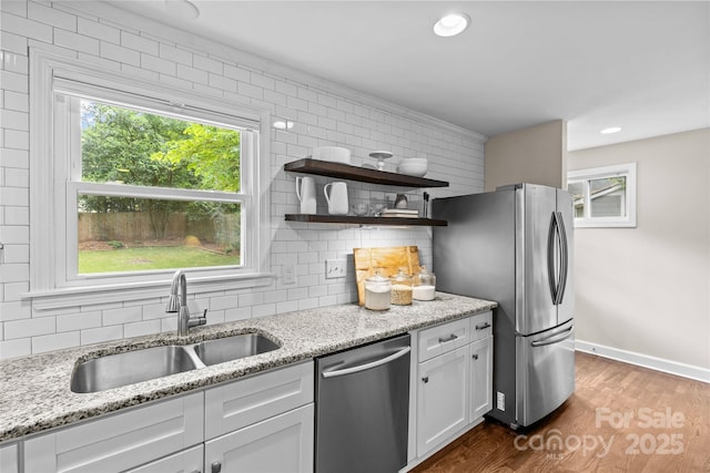 kitchen featuring tasteful backsplash, open shelves, a sink, stainless steel appliances, and dark wood-type flooring