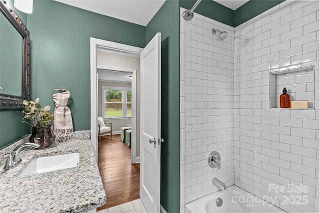 bathroom with baseboards, shower / bathing tub combination, vanity, and wood finished floors