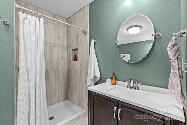 full bathroom featuring vanity and a shower stall