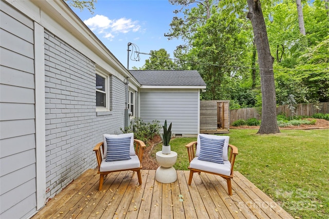 deck featuring a yard and fence