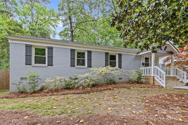 ranch-style house featuring brick siding, fence, and crawl space