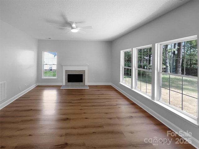 9830 Sandman Ln, Charlotte, NC 28216 - unfurnished living room with ceiling fan, baseboards, and wood finished floors