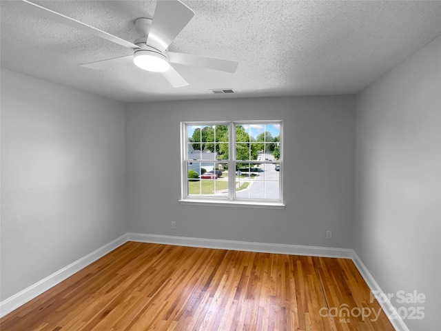 9830 Sandman Ln, Charlotte, NC 28216 - unfurnished room featuring baseboards, wood finished floors, visible vents, and a textured ceiling