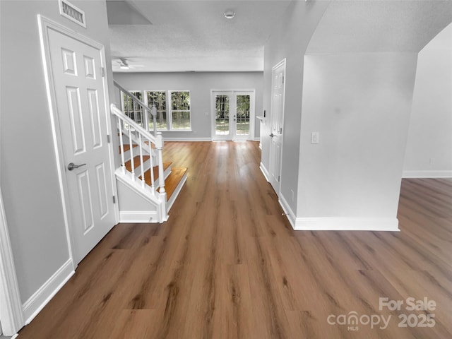9830 Sandman Ln, Charlotte, NC 28216 - hallway with stairway, baseboards, wood finished floors, and visible vents