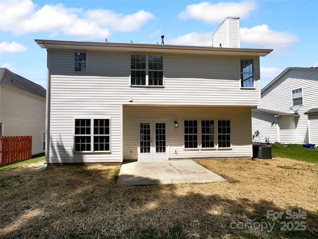 9830 Sandman Ln, Charlotte, NC 28216 - rear view of house featuring a chimney, fence, cooling unit, french doors, and a patio