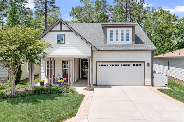 4902 Looking Glass Trl, Denver, NC 28037 - view of front facade with covered porch, a front yard, a garage, concrete driveway, and a shingled roof