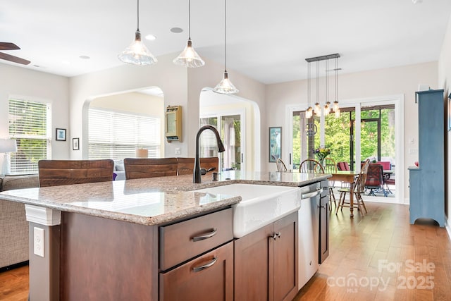 4902 Looking Glass Trl, Denver, NC 28037 - kitchen featuring light wood-type flooring, a sink, light stone counters, and a wealth of natural light