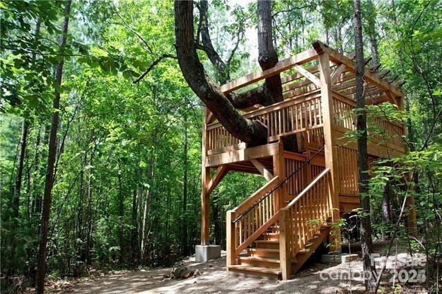 4902 Looking Glass Trl, Denver, NC 28037 - view of play area with a wooden deck, stairway, and a forest view