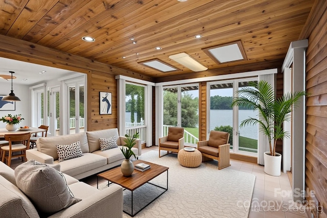 sunroom with french doors and a water view