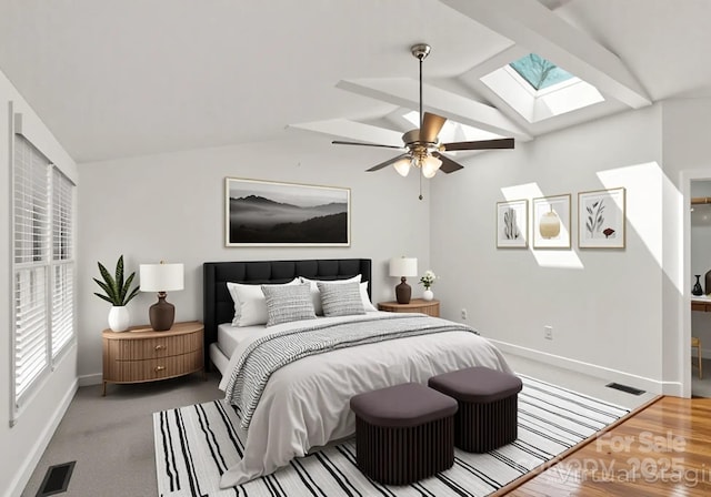 bedroom featuring visible vents, baseboards, ceiling fan, and vaulted ceiling with skylight