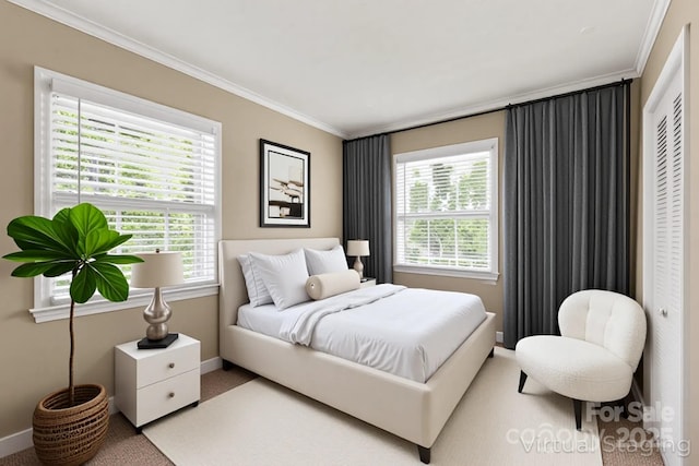 carpeted bedroom featuring baseboards, ornamental molding, and multiple windows