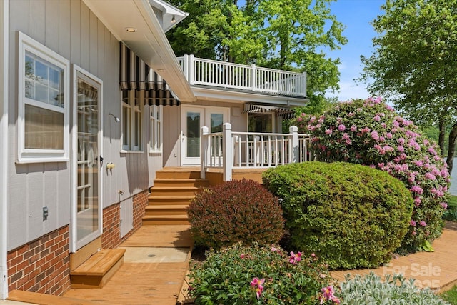 exterior space with a balcony and french doors