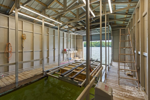 miscellaneous room featuring a water view and vaulted ceiling