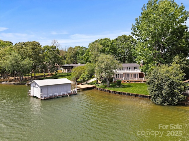dock area featuring a lawn and a water view