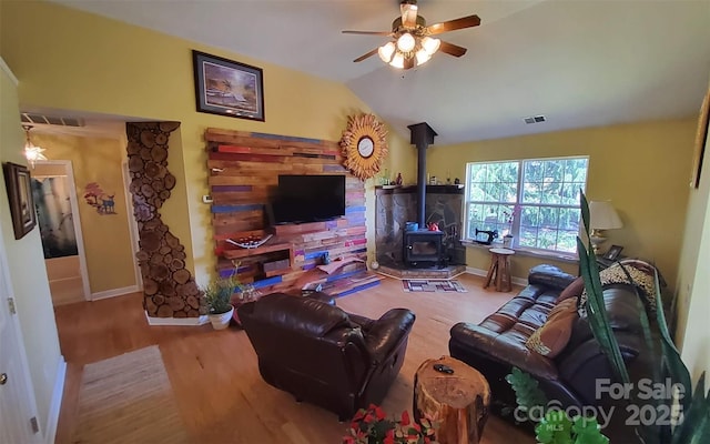 6454 Sain Milling Rd, Vale, NC 28168 - living room with wood finished floors, visible vents, baseboards, ceiling fan, and a wood stove
