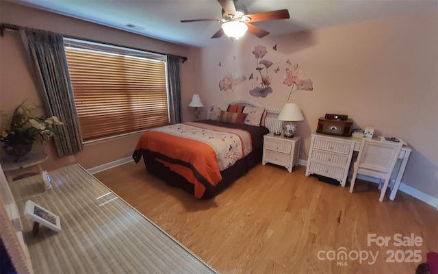 6454 Sain Milling Rd, Vale, NC 28168 - bedroom with wood finished floors, visible vents, baseboards, and a ceiling fan