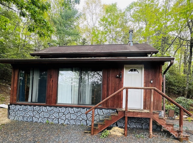 exterior space with a shingled roof