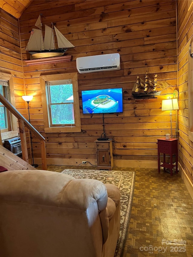 living area with wooden walls, a wall unit AC, and lofted ceiling