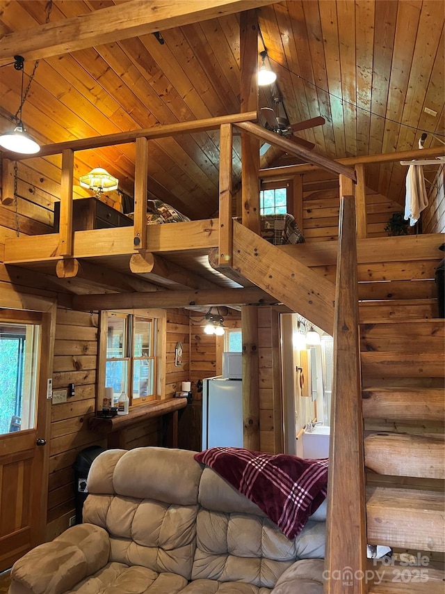 living room featuring wooden ceiling, wood walls, and high vaulted ceiling