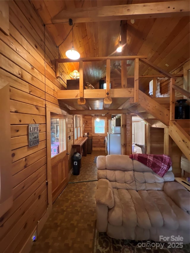 interior space featuring wood walls, wooden ceiling, carpet floors, beamed ceiling, and high vaulted ceiling