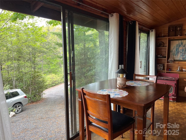 dining room with wooden ceiling and lofted ceiling