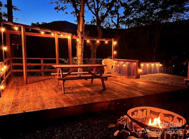 deck at twilight with an outdoor fire pit