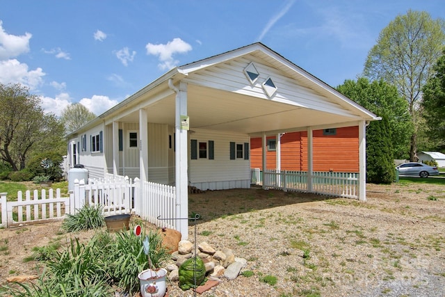 222 Pike Pt, Waynesville, NC 28785 - view of front facade with fence, driveway, and an attached carport