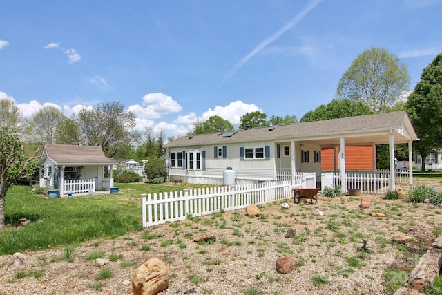 222 Pike Pt, Waynesville, NC 28785 - rear view of house featuring a yard, fence, and covered porch